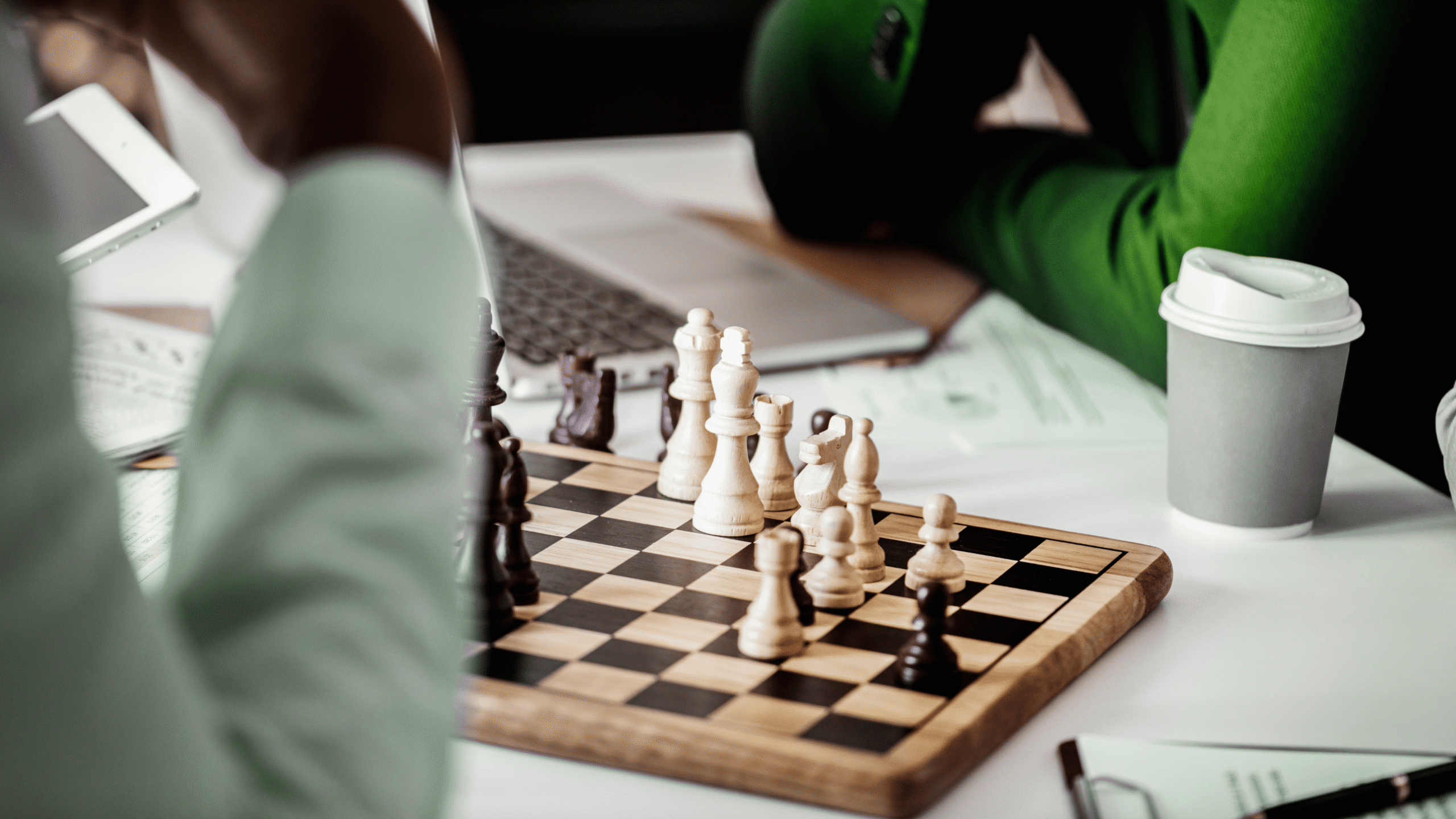 Business strategy discussion over a chessboard during a team meeting.